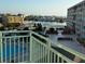 Aerial view showcases the pool, parking, and complex buildings overlooking waterfront views at 1 Key Capri # 502E, Treasure Island, FL 33706
