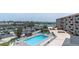 Aerial view showcases the pool, parking, boat docks, and complex buildings overlooking waterfront views at 1 Key Capri # 502E, Treasure Island, FL 33706