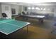The room has a billiards table, a ping pong table and chairs at 1 Key Capri # 502E, Treasure Island, FL 33706