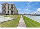 Condominium complex with waterfront views, marina access, and manicured landscaping; perfect for outdoor living at 1 Key Capri # 502E, Treasure Island, FL 33706