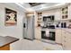Well-equipped kitchen with stainless steel appliances, light cabinets, and stylish countertops at 1 Key Capri # 502E, Treasure Island, FL 33706