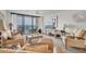 Inviting living room features plush seating and a large window with views of the marina and waterfront at 1 Key Capri # 502E, Treasure Island, FL 33706