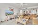 Bright and airy living room with comfortable seating, neutral decor, and a view into the dining area at 1 Key Capri # 502E, Treasure Island, FL 33706