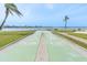 Outdoor shuffleboard court with waterfront view and palm trees at 1 Key Capri # 502E, Treasure Island, FL 33706