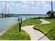 Picturesque waterfront with paddleboarders on the channel and a landscaped walkway at 1 Key Capri # 502E, Treasure Island, FL 33706