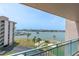 Scenic waterfront view from the balcony overlooking a marina, boat docks, and the open water at 1 Key Capri # 502E, Treasure Island, FL 33706