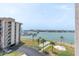 Waterfront view from a high-rise condo, featuring shuffleboard courts, marina, and Gulf at 1 Key Capri # 502E, Treasure Island, FL 33706