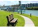 Picturesque waterfront view featuring a park bench, grassy lawn, and boat docks at 1 Key Capri # 502E, Treasure Island, FL 33706