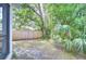 A tranquil backyard featuring a wooden privacy fence and mature landscaping, creating a peaceful outdoor oasis at 1051 44Th S St, St Petersburg, FL 33711