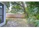 A verdant backyard with a wooden privacy fence and lush foliage offers a secluded and serene outdoor retreat at 1051 44Th S St, St Petersburg, FL 33711