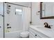 Clean bathroom featuring a white vanity, shower with white subway tile, and black fixtures at 1051 44Th S St, St Petersburg, FL 33711
