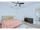 Bright bedroom featuring wood floors, two closets, and a ceiling fan with light at 1051 44Th S St, St Petersburg, FL 33711