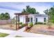 Beautifully maintained home with a decorative walkway trellis and solar panels providing modern efficiency and curb appeal at 1051 44Th S St, St Petersburg, FL 33711