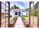 Inviting home with a decorative walkway trellis and flower boxes, creating a warm and aesthetically pleasing entrance at 1051 44Th S St, St Petersburg, FL 33711