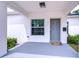 Welcoming covered front porch with gray flooring, a gray front door, and a window with blinds at 1051 44Th S St, St Petersburg, FL 33711