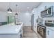 Well-equipped kitchen with white cabinets, stainless steel appliances, and a large island counter at 1051 44Th S St, St Petersburg, FL 33711
