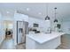 Modern kitchen with stainless steel appliances, hardwood floors, white cabinets, and a breakfast bar at 1051 44Th S St, St Petersburg, FL 33711