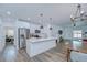 Spacious open concept kitchen and dining area with stainless steel appliances and hardwood floors at 1051 44Th S St, St Petersburg, FL 33711