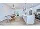 Open concept kitchen and dining area with modern appliances, hardwood floors, and bright lighting at 1051 44Th S St, St Petersburg, FL 33711