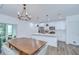 Bright eat-in kitchen featuring modern pendant lights, hardwood floors, and stainless steel appliances at 1051 44Th S St, St Petersburg, FL 33711