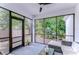 Screened in lanai with comfortable seating and a view of the backyard at 1051 44Th S St, St Petersburg, FL 33711