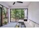 Screened in lanai with comfortable seating and a view of the backyard at 1051 44Th S St, St Petersburg, FL 33711