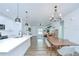 Bright and airy open-concept living space with hardwood floors and modern lighting fixtures at 1051 44Th S St, St Petersburg, FL 33711