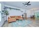 Open living room with hardwood floors, modern ceiling fan, and unique cat climbing shelves at 1051 44Th S St, St Petersburg, FL 33711