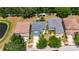 A bird's eye view showcases a well-maintained neighborhood with lush greenery and a tranquil pond at 10636 Dawns Light Dr, Riverview, FL 33578