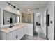Bathroom featuring vanity with sink, tiled walk-in shower, and gray floors at 10636 Dawns Light Dr, Riverview, FL 33578