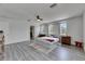 Spacious bedroom featuring a ceiling fan, wood-look flooring, and closet access at 10636 Dawns Light Dr, Riverview, FL 33578