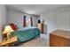 Cozy bedroom with wood-look floors, large window, and ample space for a bed and dresser at 10636 Dawns Light Dr, Riverview, FL 33578