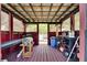 Outdoor cabana featuring a sheltered space, corrugated steel roof, and various grilling equipment at 10636 Dawns Light Dr, Riverview, FL 33578