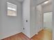 Hallway with light wood flooring and a window at 10636 Dawns Light Dr, Riverview, FL 33578