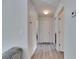 Hallway featuring wood-look flooring and white walls with doors leading to various rooms at 10636 Dawns Light Dr, Riverview, FL 33578