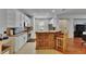 Bright kitchen with stainless appliances, wooden bar with chairs, and tiled floors at 10636 Dawns Light Dr, Riverview, FL 33578