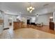 Open-concept living space connecting the kitchen to the living room with hardwood floors at 10636 Dawns Light Dr, Riverview, FL 33578