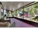 Inviting screened-in patio with cozy furniture, offering serene views of the backyard and surrounding greenery at 10636 Dawns Light Dr, Riverview, FL 33578