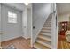 Bright stairway with wood stairs and white risers leads to the upper level of the home at 10636 Dawns Light Dr, Riverview, FL 33578