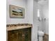 Bathroom featuring a marble countertop and dark wood cabinet at 10701 Village Green Ave, Seminole, FL 33772