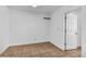 Cozy bedroom with tile flooring, white walls, and a closet for storage at 10701 Village Green Ave, Seminole, FL 33772