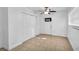 Bright bedroom featuring a ceiling fan, closet, and tile flooring at 10701 Village Green Ave, Seminole, FL 33772