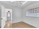 Well-lit bedroom with tile flooring, white walls, and an exit door at 10701 Village Green Ave, Seminole, FL 33772