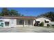 Charming single-story home with ample parking, awnings, and well-maintained landscaping at 10701 Village Green Ave, Seminole, FL 33772