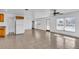 Open living space with tile floors, natural light, ceiling fan, and kitchen access at 10701 Village Green Ave, Seminole, FL 33772