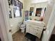 Bathroom with accessible features, including a toilet support, vanity, and large mirror at 1101 Alcazar S Way, St Petersburg, FL 33705