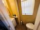 Small bathroom featuring a toilet under a window and a sink with storage beneath, offering basic amenities at 1101 Alcazar S Way, St Petersburg, FL 33705