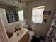 Bathroom features a vanity with sink, toilet, shower and a window for natural light at 1101 Alcazar S Way, St Petersburg, FL 33705