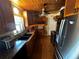 Well-lit kitchen with stainless steel appliances, wooden cabinets, granite countertops, and unique wood plank ceiling at 1101 Alcazar S Way, St Petersburg, FL 33705