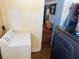 Laundry area showing a white washing machine and an open doorway, leading to a living area at 1101 Alcazar S Way, St Petersburg, FL 33705